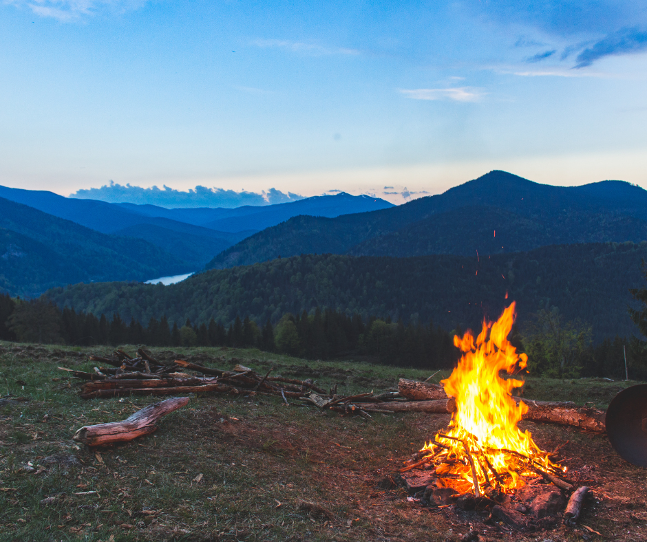 Fired Up about the Canadian Disability Benefit A campfire is in the foreground and mountains in the background with the dawn of the new day behind them