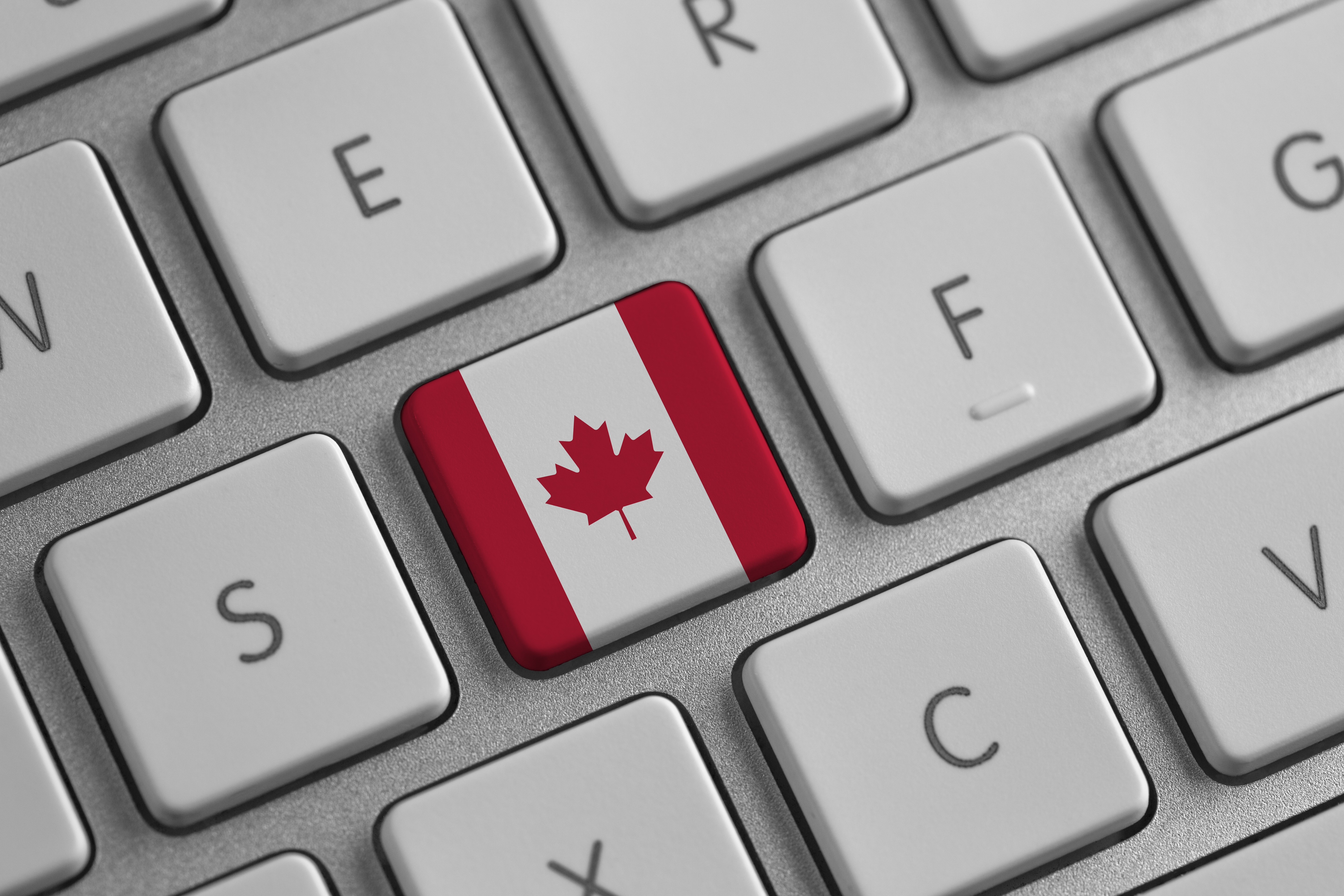 a computer keyboard with a Canada flag symbol symbolizing a letter writing campaign