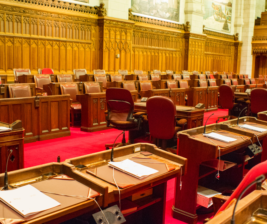 The senate chamber with empty seats and the red carpet.