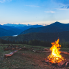 Fired Up about the Canadian Disability Benefit A campfire is in the foreground and mountains in the background with the dawn of the new day behind them