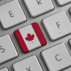 a computer keyboard with a Canada flag symbol symbolizing a letter writing campaign